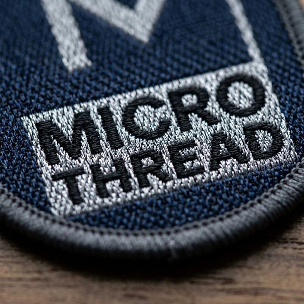 Extreme macro photograph of microscopic woven jacquard damask threads and tiny typography